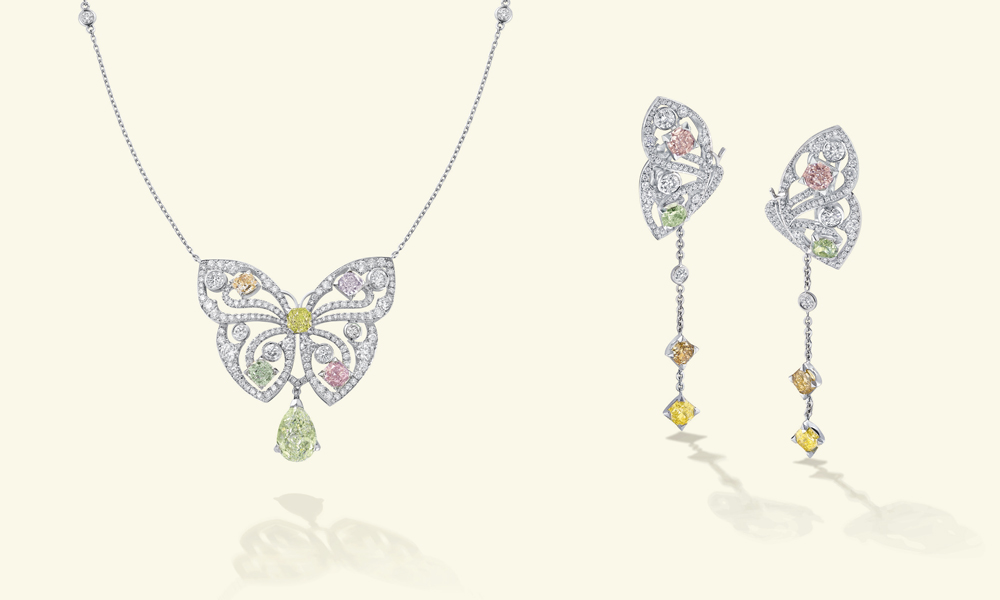 Papillon pendant featuring a selection of coloured diamonds including a stunning yellowish green pear-shaped diamond drop of over two carats and Papillon earrings with wings adorned by almost four carats of fancy coloured diamonds and diamond drops that suggest the fluttering of flight.