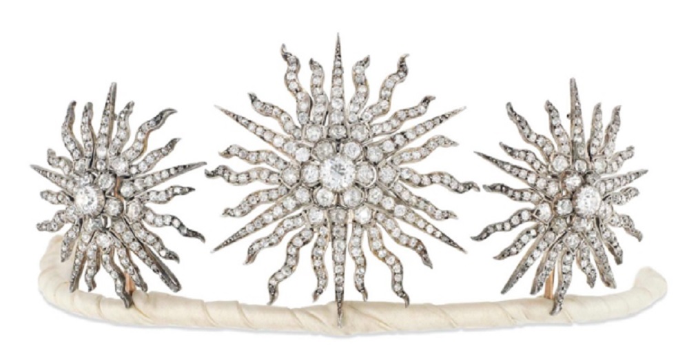 An Edwardian diamond tiara. Designed as a group of three old brilliant-cut diamond graduated sunburst star panels, each with central diamond cluster to a radiating surround of similarly-set rays, mounted in silver and gold, detaching to form three brooches or a hair slide, four additional fittings, circa 1900. Largest star 5.7cm, in fitted case. Sold for £15,000 on 30 November 2016 at Christie’s in London