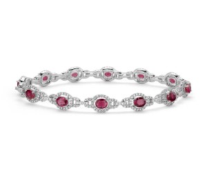 Ruby and Diamond Halo Bracelet in 14k White Gold (5x4mm)     Captivating in color, this bracelet features vibrant ruby gemstones accented with a halo of sparkling round diamonds framed in 14k white gold. 