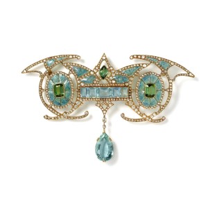 Art Nouveau yellow gold brooch designed with a central aquamarine panel carrying an aquamarine drop, set between two green tourmalines, within enamelled ovals with diamonds, by Georges Fouquet, Paris. Available at Hancocks. 