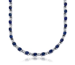 Sapphire and Diamond Necklace in 18k White Gold (5x4mm)     Forty-four vibrant blue sapphires are highlighted with a semi-bezel setting, and interspersed with brilliant prong-set diamonds.  