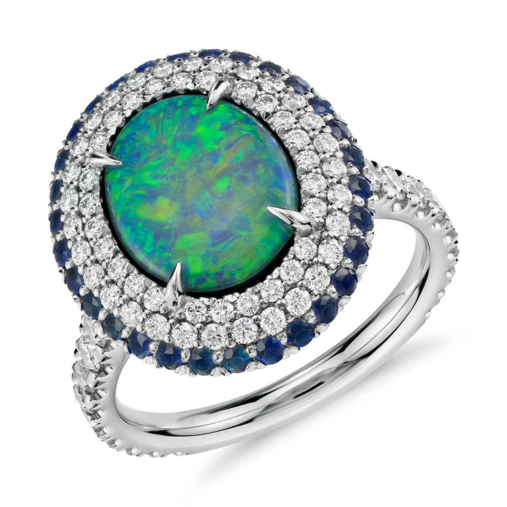 Black Opal and Diamond and Sapphire Halo Ring in Platinum (2.33 ct center) (11x9mm)at Blue Nile Distinctly glamorous, this one-of-a-kind gemstone ring features a stunning 2.33ct black opal surrounded by a halo of pavé-set diamonds and blue sapphires framed in enduring platinum. 