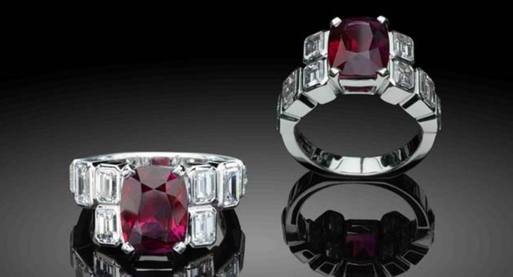 Extravagant art deco-style ruby ring from Star Diamond Private Jeweller featuring a deep red ruby flanked by emerald-cut diamonds.