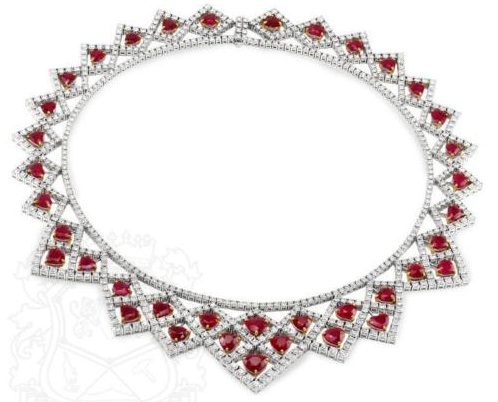 A necklace that both Cupid and Eros would love!!! This stunning ruby necklace of angular collar design is a masterful assembly of 38.73cts of round brilliant diamonds bordering and enclosing 46.13cts of gorgeously vivid heart shaped rubies. The necklace is meticulously crafted of 18k white gold, with each ruby glowing from its own personal 18k yellow gold setting. Something about this ruby necklace screams Valentine’s Day 1928. Something else about this ruby necklace screams Valentine’s Day 2016. Certainly a vibrant and even festive piece of ruby and diamond jewelry, it is truly a work of art that you might consider displaying for its enjoyment when you''re not out on the town.
