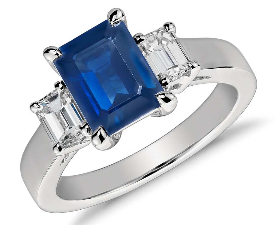 Emerald Cut Sapphire and Diamond Ring in Platinum (8x6mm) Elegantly refined, this gemstone and diamond ring showcases an emerald cut sapphire complemented by two matching emerald cut diamonds and set in enduring platinum.