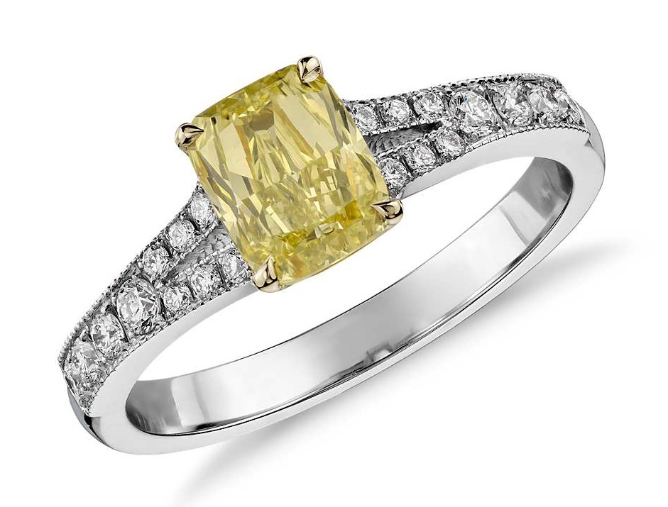 Fancy Yellow Cushion Diamond Ring in 18k White Gold (1.06 ct) Decadently detailed, this one-of-a-kind diamond ring showcases a fancy intense yellow cushion cut diamond framed by micropavé diamonds. Accompanied by a GIA Diamond Grading Report for the diamond.