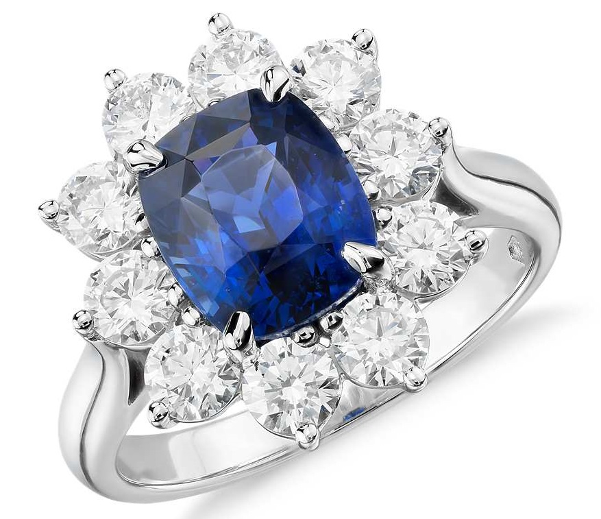 Sapphire and Diamond Halo Ring in Platinum (3.17 ct.center) Stunning and classic, this gemstone and diamond ring makes a statement with an extraordinary 3.17 carat cushion-shaped sapphire surrounded by over a carat of brilliant round diamonds set in platinum. Sapphire is accompanied by a gemstone report confirming it is not heat treated.
