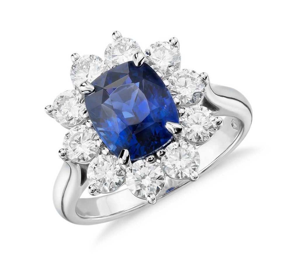 Sapphire and Diamond Halo Ring in Platinum (3.17 ct.center) Stunning and classic, this gemstone and diamond ring makes a statement with an extraordinary 3.17 carat cushion-shaped sapphire surrounded by over a carat of brilliant round diamonds set in platinum. Sapphire is accompanied by a gemstone report confirming it is not heat treated.