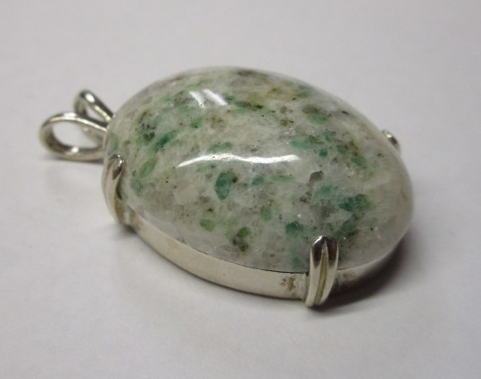  A beautiful custom-cut emerald in matrix mounted in a pendant. 