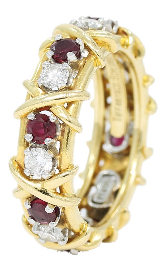 Tiffany & Co. Schlumberger diamond and ruby ring made in 18k yellow gold and platinum. This is part of the 16 stone collection. Ring is a size 6. All stones are set in platinum. There is 1.60ctw of round brilliant cut diamonds and round rubies. Diamonds have a color of E-F and a clarity of VVS-VS. This is an estate ring with light wear on the platinum and gold. Some of the rubies have light abrasion at the facet junctions. Ring retailed for $8,000.00. Total weight of ring is 8 grams. 