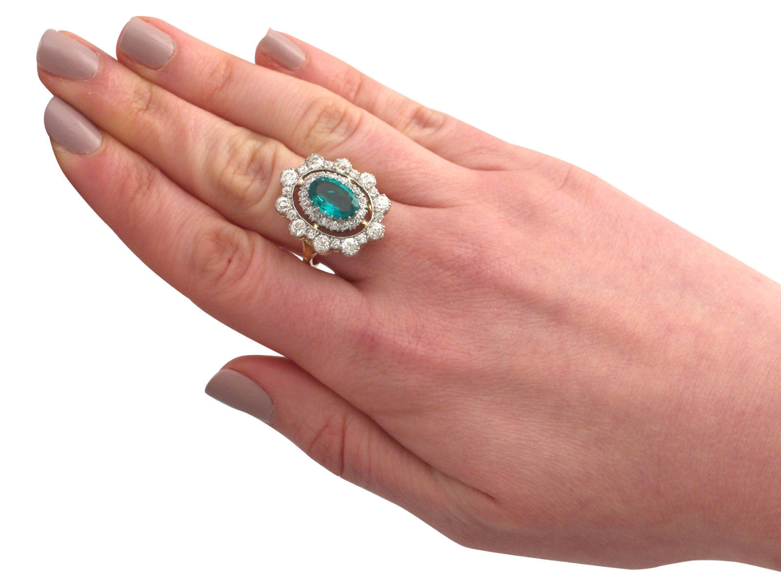 This stunning antique 1930's cocktail ring is exceptional quality set with an emerald and very well colour matched, very high colour graded old cut diamonds. The ring is an exceptional gauge of gold and is in excellent condition.