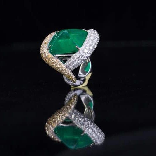 A 16.95 carat Colombian Emerald sugar loaf ring by Smart Arts. 