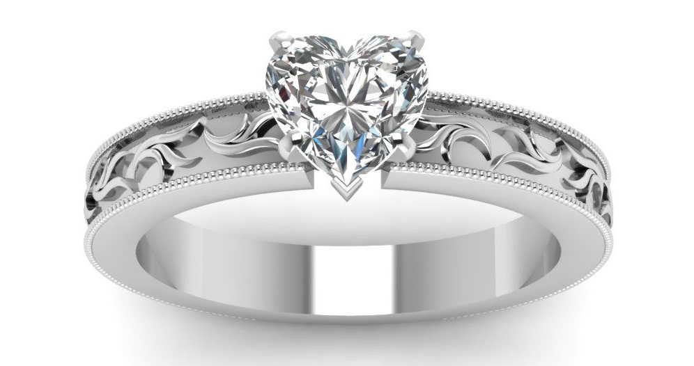This heart shaped diamond solitaire twig design engagement ring has a GIA Certified 0.80 Ct Diamond Cut:Very Good SI1-H Color. This engagement ring is enhanced by an intricate leaf pattern in a sequence and a milgrain outline all around the ring.