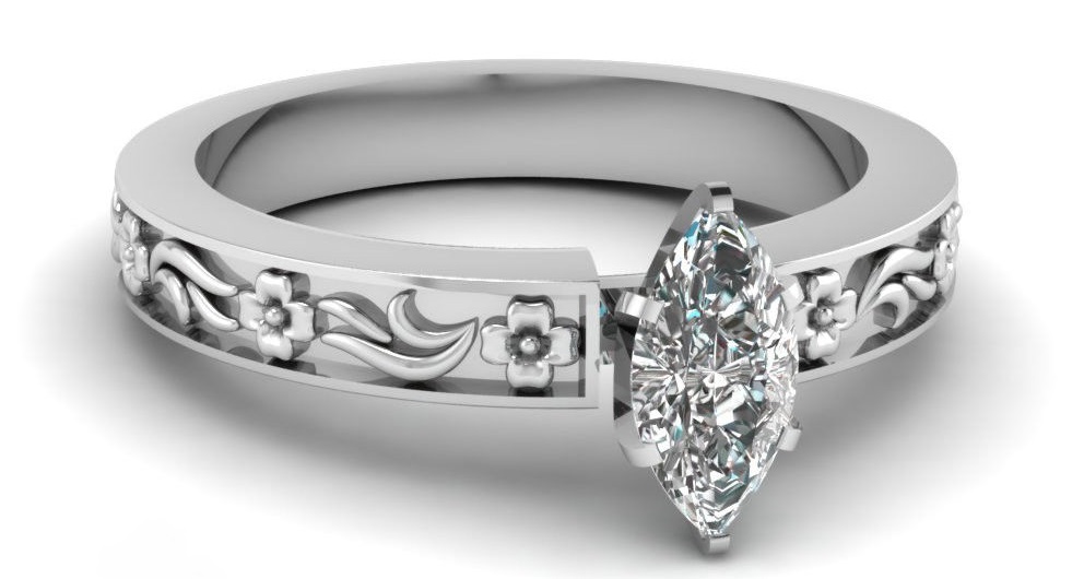 This marquise cut diamond solitaire engagement ring has a GIA Certified 0.50 Ct Diamond Cut:Very Good VVS1-D Color. This engagement ring is enhanced by a delicate floral pattern on the shank of the ring giving it an artistic appeal to it.