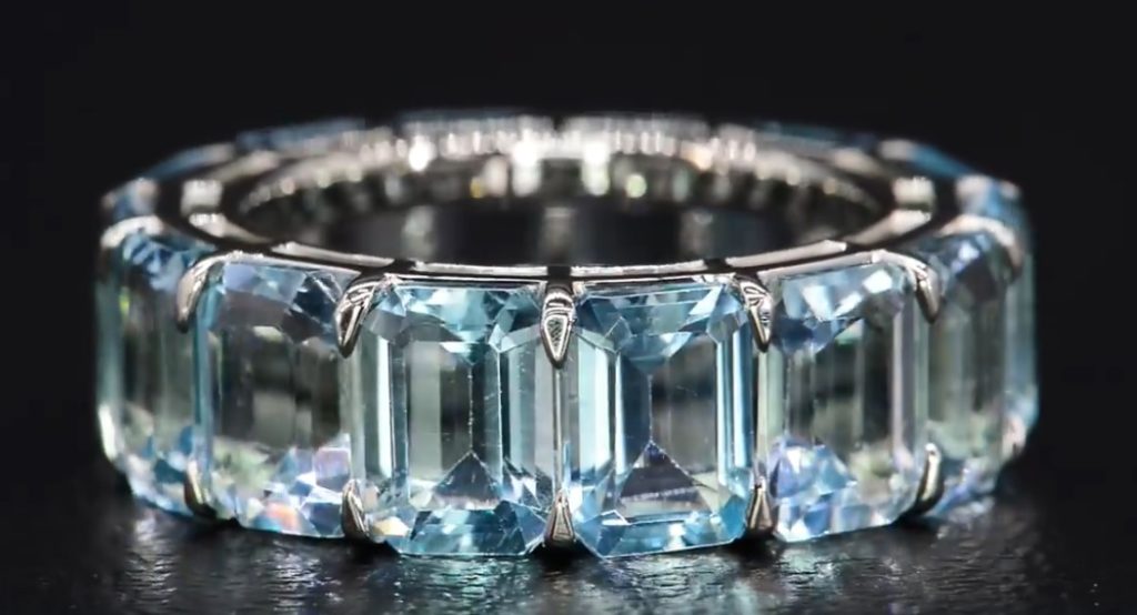 A gorgeous eternity band with natural, untreated, emerald-cut blue topaz gemstones.